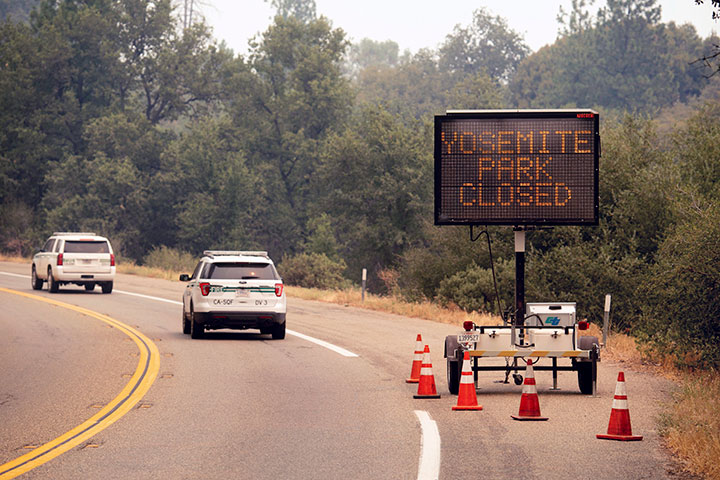 A sign on Highway 41 announces the closure of Yosemite National Park near Oakhurst, Calif., on Wednesday, July 25, 2018.