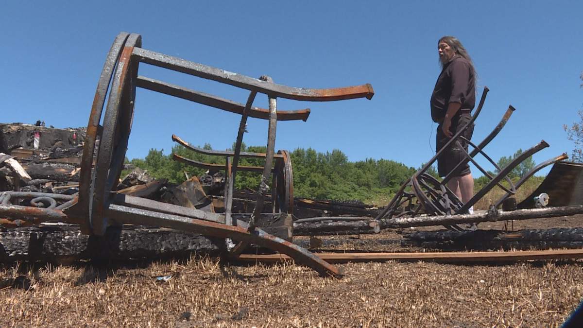 Kanesatake Grand Chief Serge Otsi Simon surveys the burnt-out remains of the Kanesatake Youth of Today building. (Phil Carpenter/Global News)