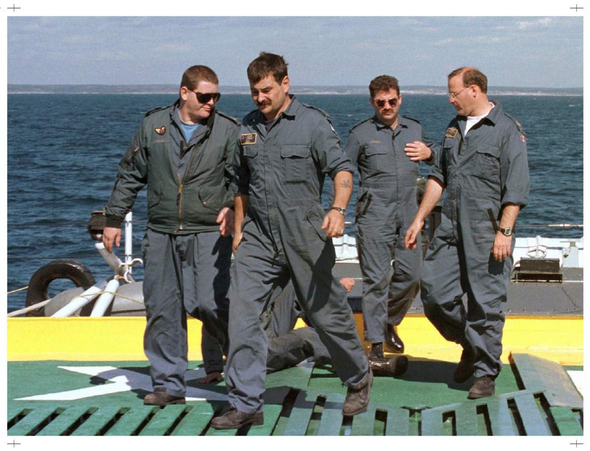 Air force Sea King technicians walk across the flight deck on HMCS Halifax off the coast of Peggy’s Cove, N.S. The aging helicopters, which required lots of maintenance, worked non-stop in support of the Swissair flight 111 recovery operation.