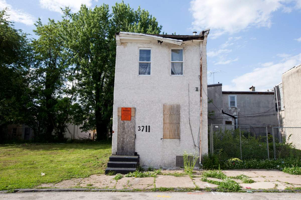 This Friday, May 23, 2014 photo, shows an abandoned home in the impoverished Mantua section of Philadelphia, before it was knocked down. 