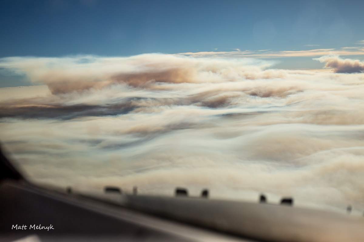 thick, heavy grey smoke billowing from the mountains.