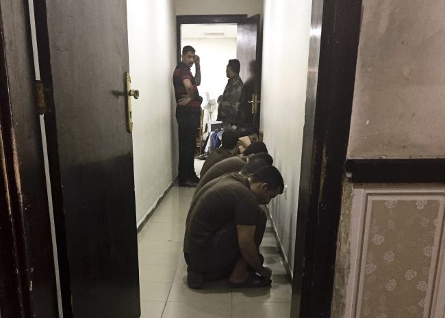 In this May 23, 2018 photo, suspected Islamic State militants wait their turn for sentencing at the counterterrorism court in Baghdad, Iraq.