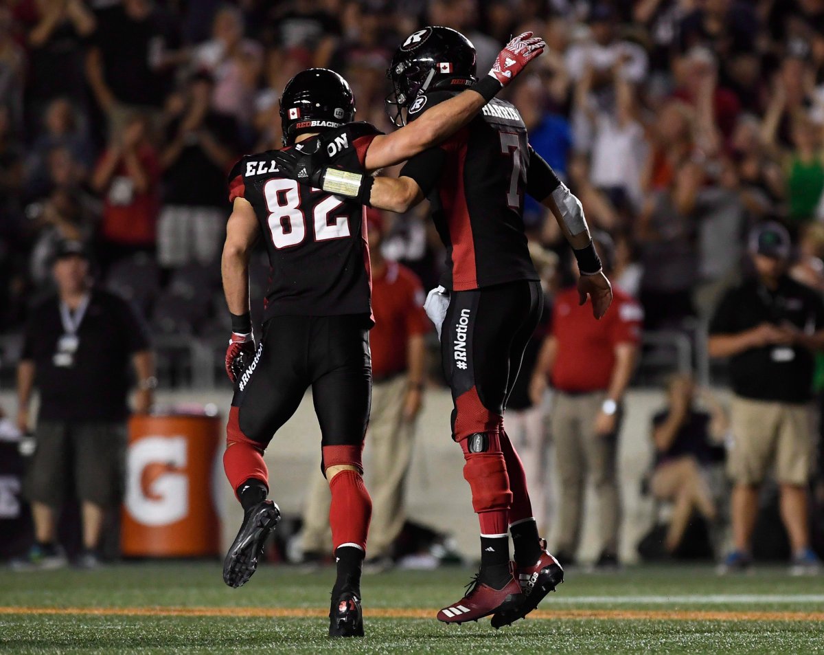 Ottawa Redblacks quarterback Trevor Harris (7) celebrates a touchdown with teammate Greg Ellingson (82) during second-half CFL action against the B.C. Lions in Ottawa on Friday, July 20.