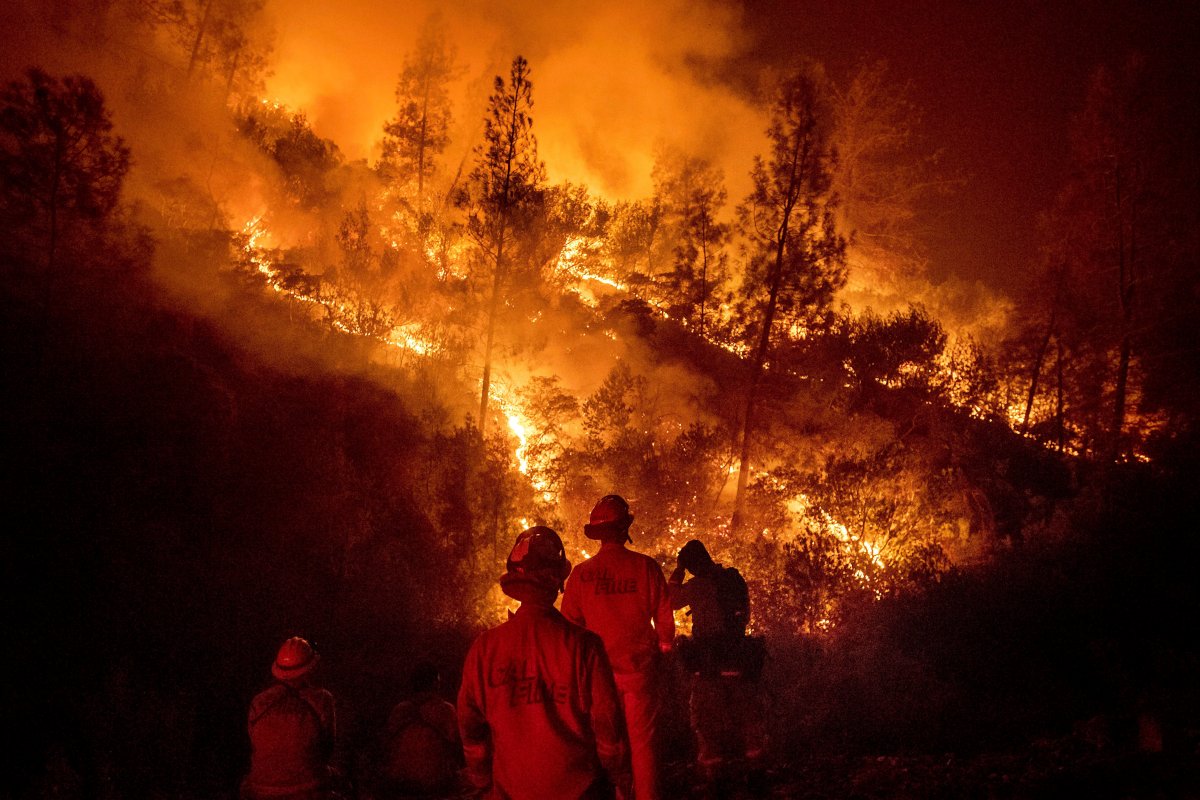 Firefighters monitor a backfire while battling the Ranch Fire, part of the Mendocino Complex Fire, on Tuesday, Aug. 7, 2018, near Ladoga, Calif.