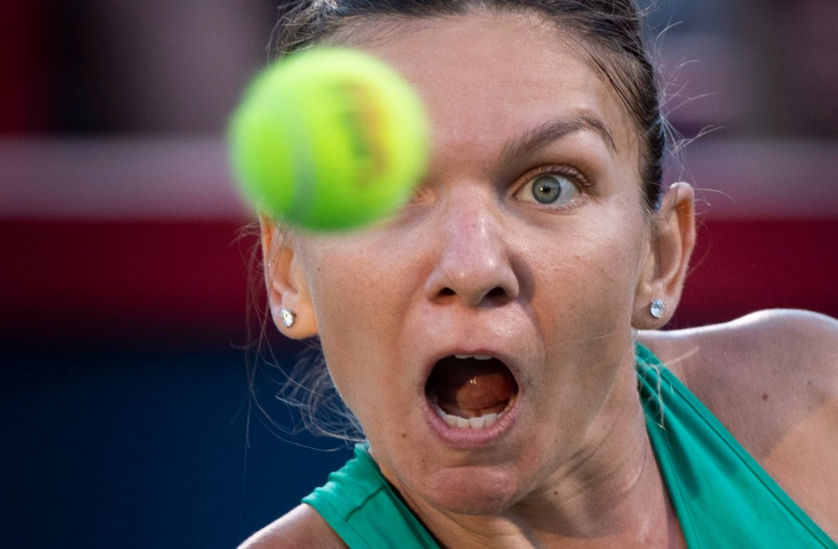 Simona Halep, of Romania, keeps an eye on the ball as she returns to Caroline Garcia, of France, during quarter-final play at the Rogers Cup tennis tournament, in Montreal on Friday, August 10, 2018. 