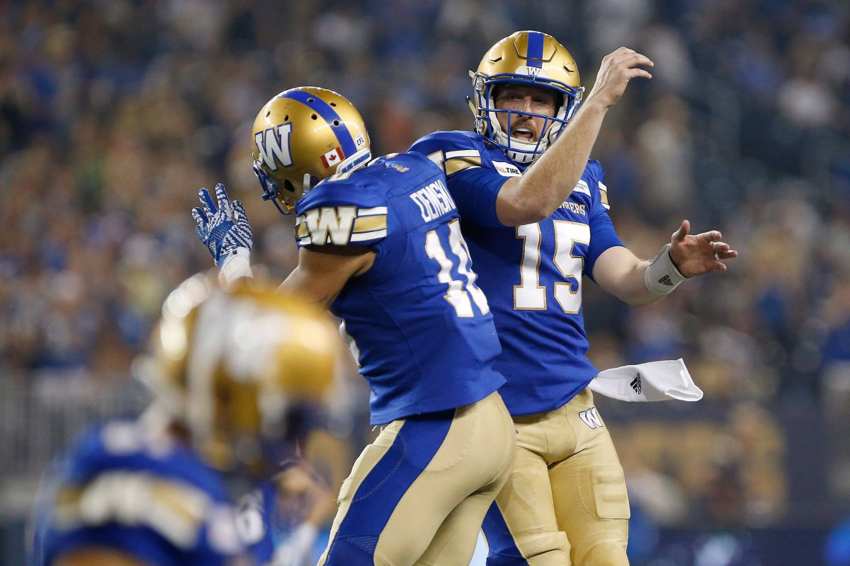 Winnipeg Blue Bombers quarterback Matt Nichols (15) and Nic Demski (10) celebrate Demski's touchdown during the second half of CFL action against the Hamilton Tiger-Cats, in Winnipeg on Friday, August 10, 2018. THE CANADIAN PRESS/John Woods.