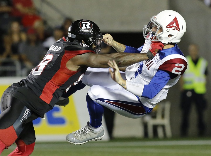 Ottawa Redblacks A.C. Leonard (99) tackles Montreal Alouettes quarterback Johnny Manziel (2) during fourth quarter CFL action in Ottawa on Saturday, August 11, 2018.  
