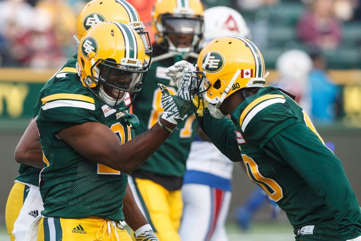 Edmonton Eskimos’ Shaquille Cooper (25) celebrates a touchdown with Bryant Mitchell (80) against the Montreal Alouettes during first half CFL action in Edmonton, Alta., on Saturday August 18, 2018.