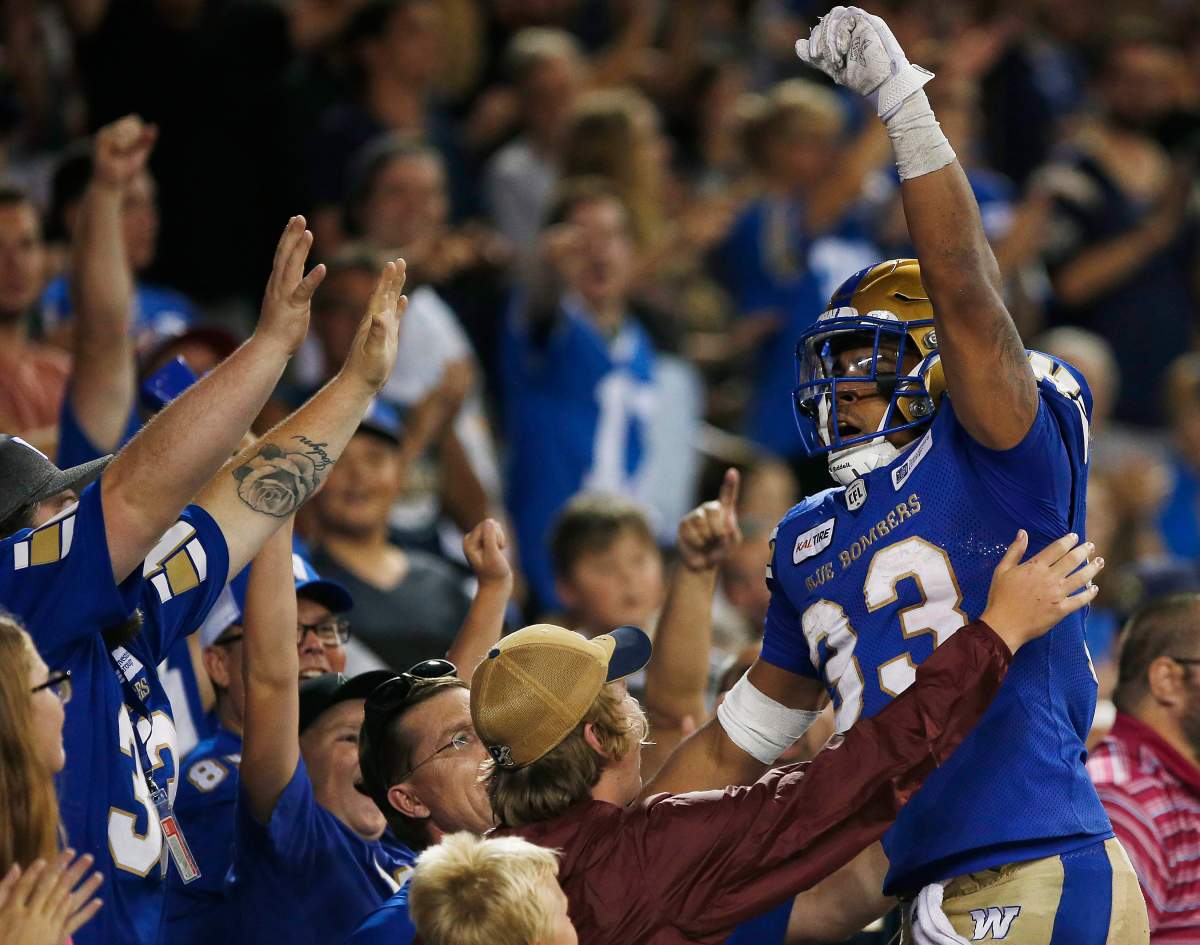 Winnipeg Blue Bombers' Andrew Harris (33) celebrates his touchdown  against the Ottawa Redblacks during the second half of CFL action in Winnipeg Friday, August 17, 2018.    THE CANADIAN PRESS/John Woods.