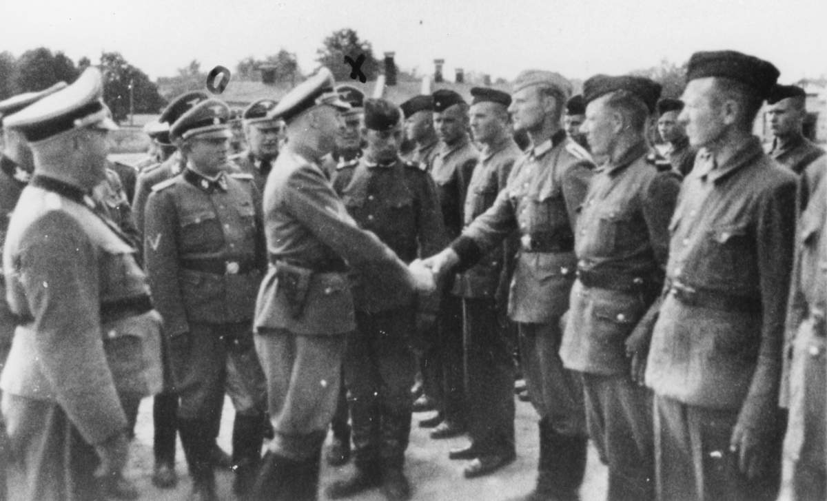 This 1942 photo provided by the the public prosecutor’s office in Hamburg via the United States Holocaust Memorial Museum, shows Heinrich Himmler, center left, shaking hands with new guard recruits at the Trawniki concentration camp in Nazi occupied Poland. Trawniki is the same camp, where some time after this photo was made, Jakiw Palij trained and served as a guard.