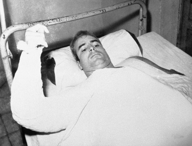 In this undated file photo provided by CBS, then Lt. Commander John S. McCain lies injured in North Vietnam.