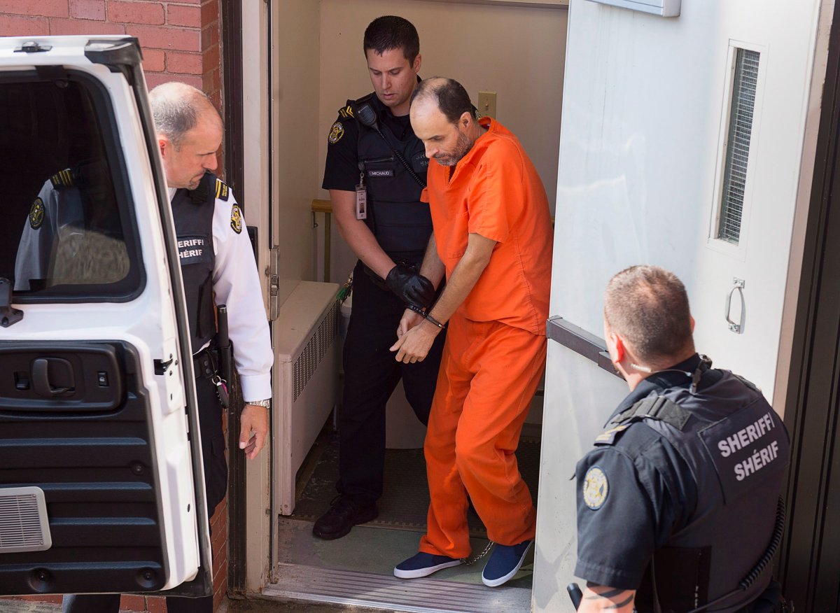 FILE - Matthew Vincent Raymond, charged with four counts of first degree murder, is taken from provincial court in Fredericton on Monday, Aug. 27, 2018.