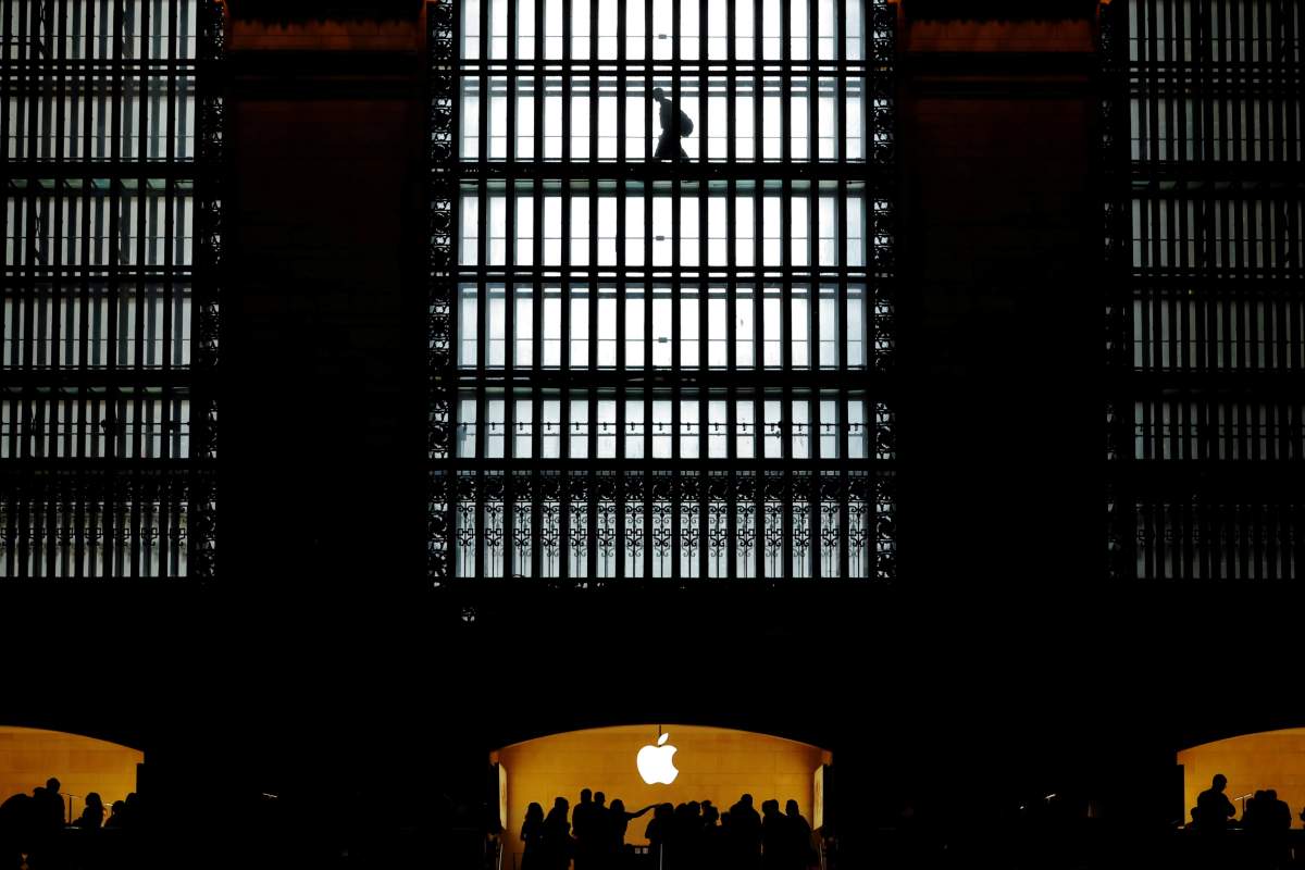 Customers walk past an Apple logo inside of an Apple store at Grand Central Station in New York, U.S., August 1, 2018.  