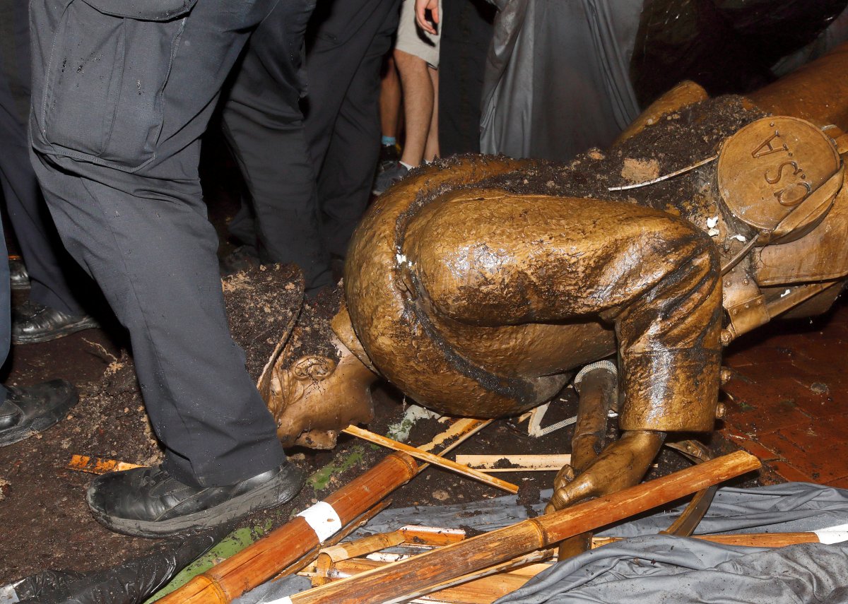 University of North Carolina police surround the toppled statue of a Confederate soldier nicknamed Silent Sam on the school's campus after a demonstration for its removal in Chapel Hill, North Carolina, U.S. August 20, 2018.  
