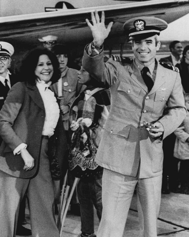 Then Lt. Cdr. John McCain, a POW for over five years, waves to well wishers after arriving at Jacksonville Naval Air Station in Florida in this March 18, 1973 file photo.