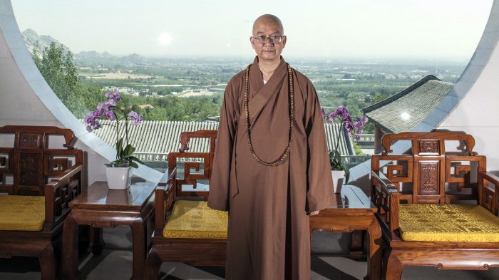 In this photo taken July 3, 2015, Abbot Xuecheng of the Beijing Longquan Temple poses for a photo in one of the temple buildings in Beijing, China. 