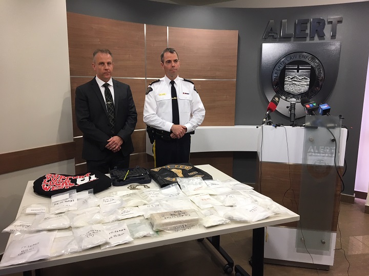 Supt. Chad Coles and Chief Supt. Ian Lawson stand behind a table of items seized during an ALERT investigation into a cocaine distribution network that allegedly involved members of the Hells Angels and support clubs.