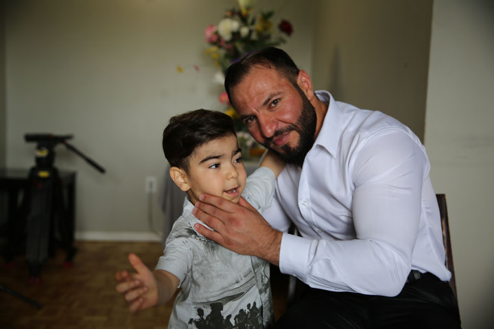 Mohammed Alkarad and his young son in their apartment in Ottawa.