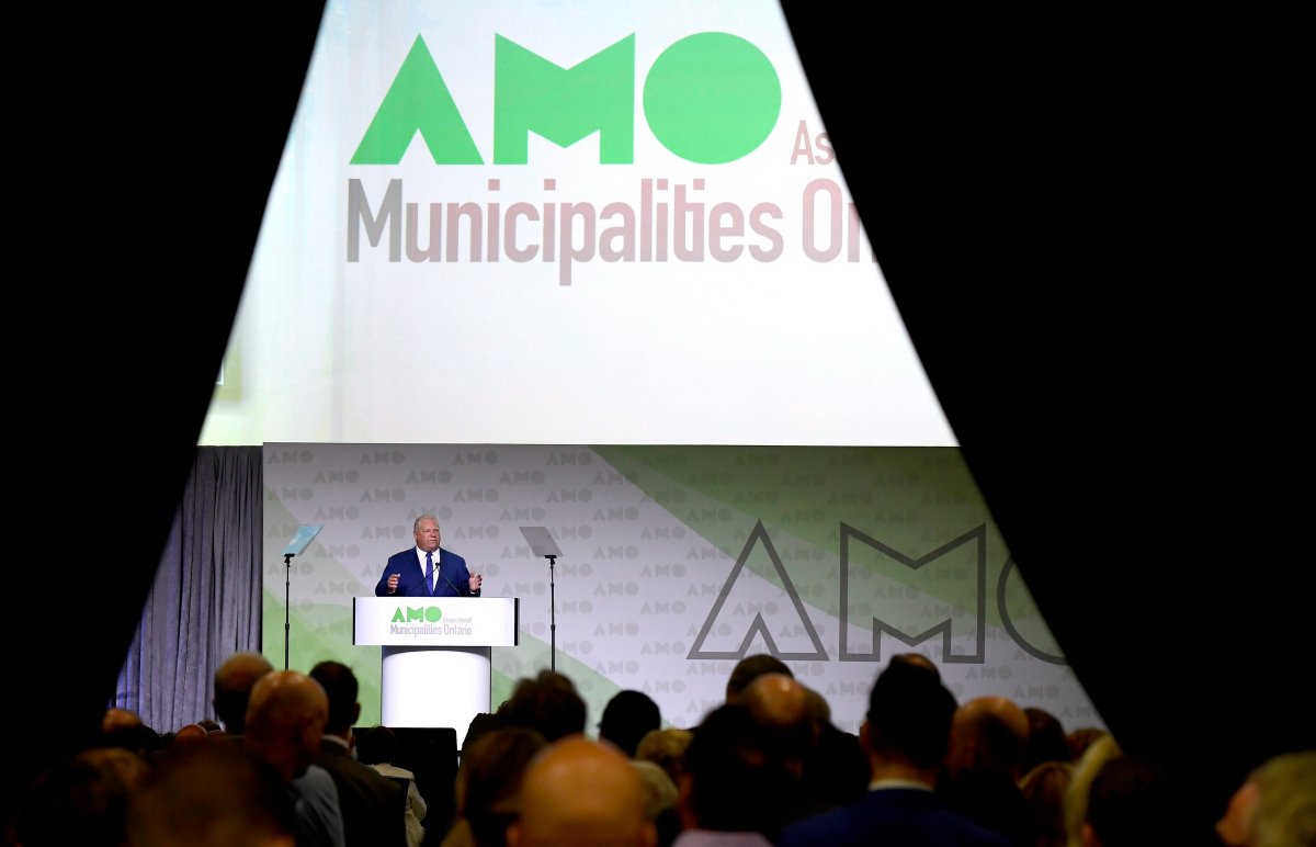 Attendees stand in the back of the room as Ontario Premier Doug Ford speaks at the Association of Municipalities of Ontario in Ottawa on Monday, August 20, 2018.