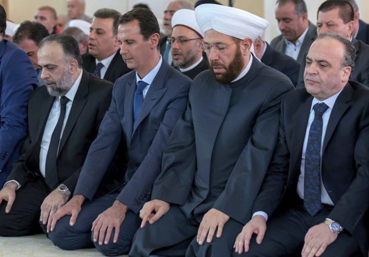 Syrian President Bashar Assad, second from left, prays on the first day of Eid al-Adha at al-Rawda mosque, in Damascus, Syria, Tuesday, Aug. 21, 2018.