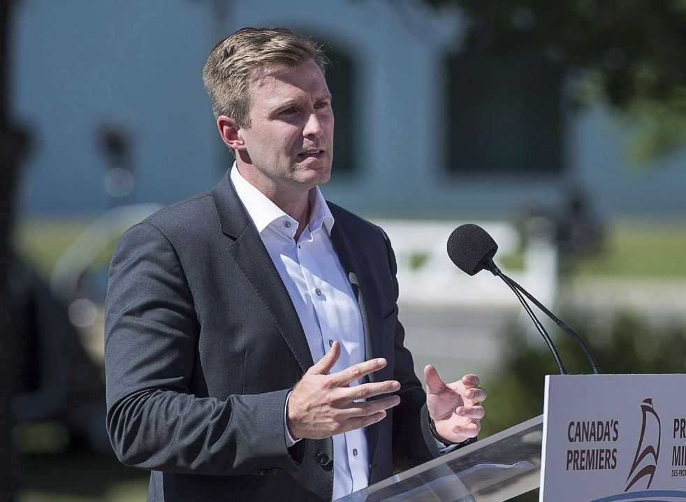 New Brunswick Premier Brian Gallant talks with reporters as the Canadian premiers meet in St. Andrews, N.B. on July 19, 2018.