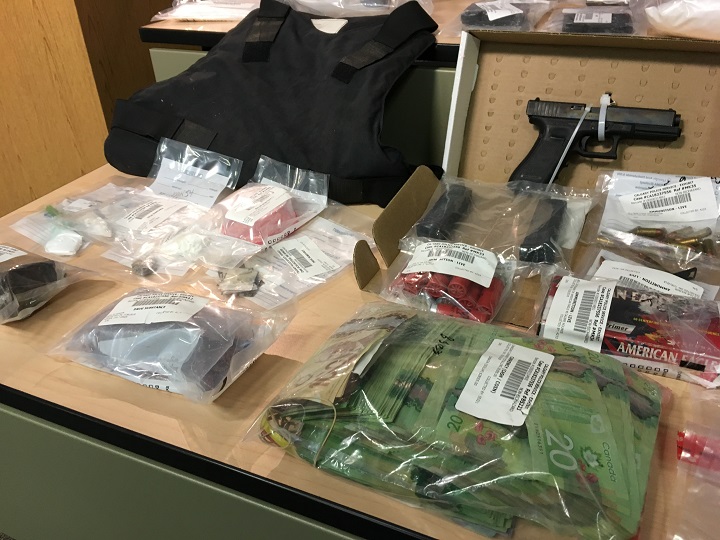Over $700,000 worth of cash and drugs is displayed Aug. 2, 2018 after an investigation in Calgary.