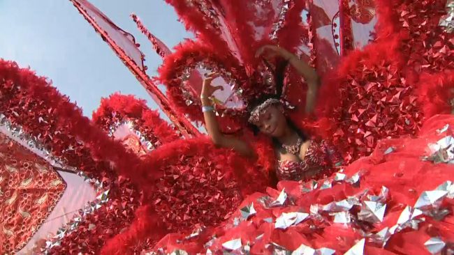 Caneisha Edwards dances along the Grande Parade route in her costume.