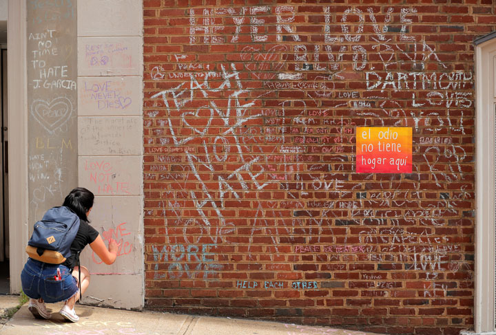 A woman draws on a wall near a memorial to Heather Heyer ahead of the one year anniversary of the 2017 Charlottesville “Unite the Right” protests in Charlottesville, Virginia, U.S., August 11, 2018.
