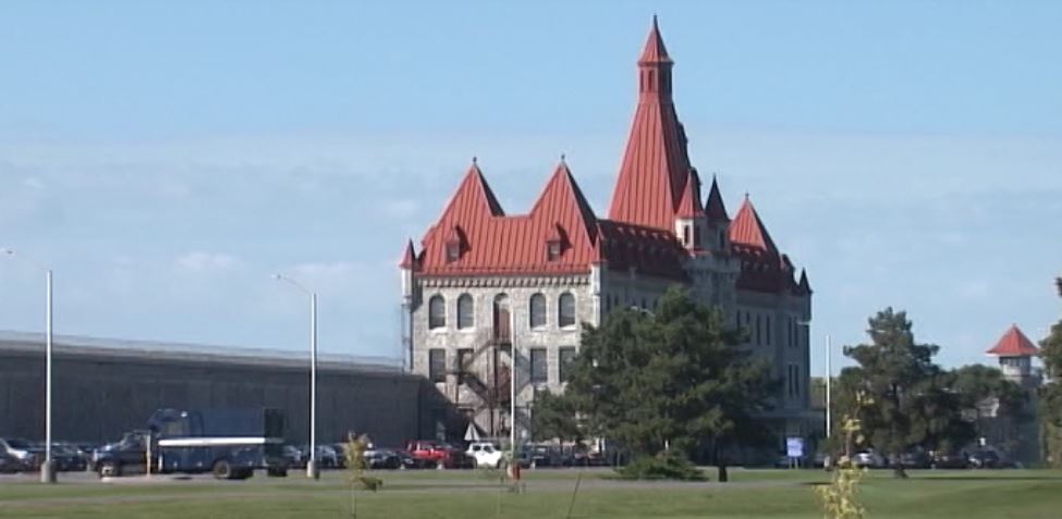 Kingston police arrested a man who was acting suspiciously outside Collins Bay penitentiary the night after an attempted package drop.