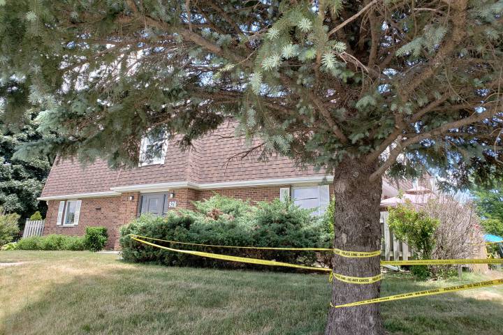 Police tape can be seen cordoning off an area of the townhouse complex on Courtland Avenue.

