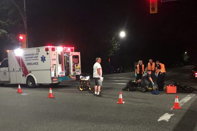 A cyclist lies on the ground after being struck down by a vehicle in Kelowna, August 9, 2018. 