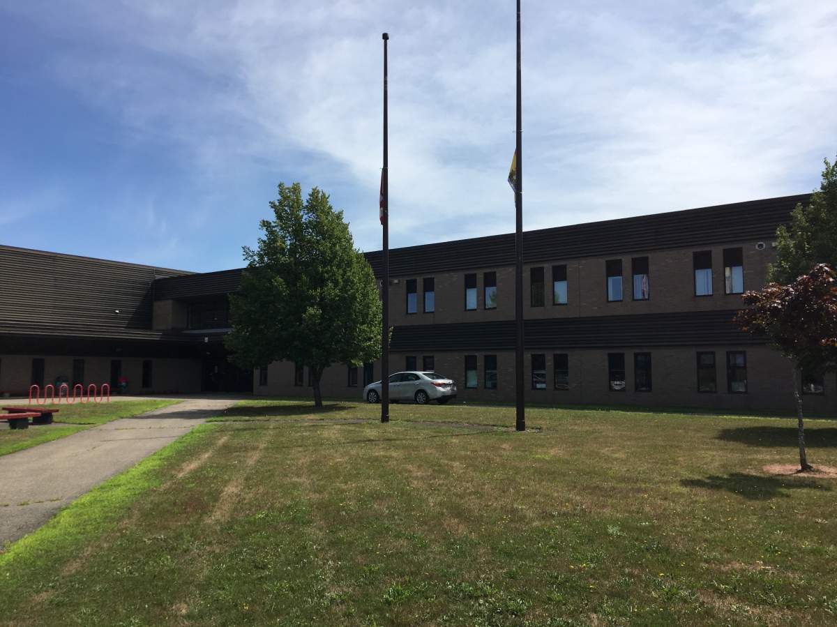 The flags at Sussex Regional High School stand at half mast to remember Const. Robb Costello who died on Friday in a fatal shooting.