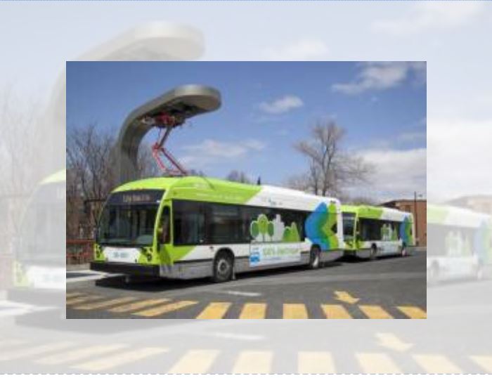 File photo of two quick-charging electric busses operating on the 36 - Monk bus route in Montreal, with a charging station above.