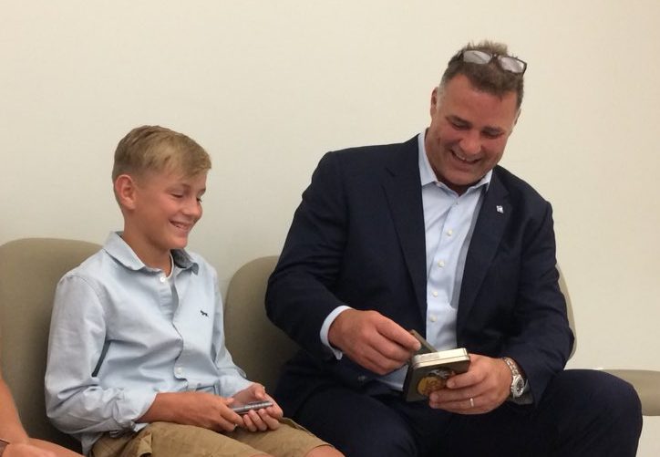 Former NHL hockey player Eric Lindros signs hockey cards for 11-year-old Sheldon Geerts, who spoke during Thursday’s celebration about the two concussions he’s had.
