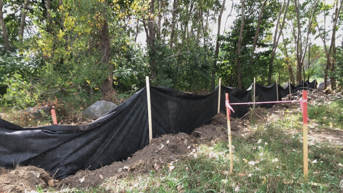 Wooden cloth fence surrounds patch of land where underground drilling will begin. Monday, August 13, 2018.
