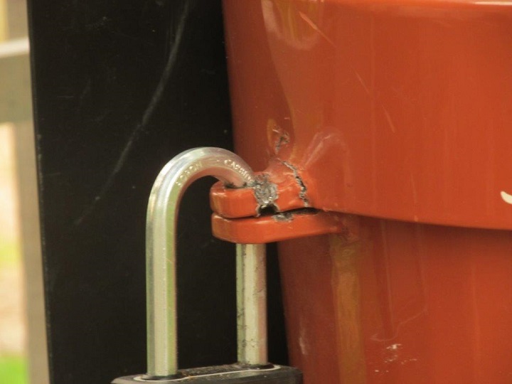 A close-up of the damage done to one of the donation boxes at Summerland Ornamental Gardens.