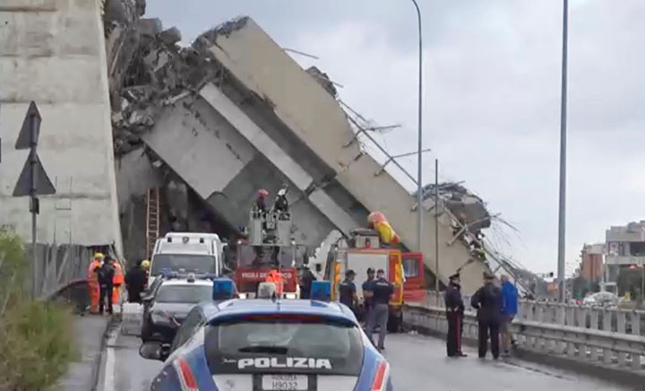Rescue workers are seen at the collapsed Morandi Bridge in the Italian port city of Genoa, August 14, 2018 in this still image taken from a video.