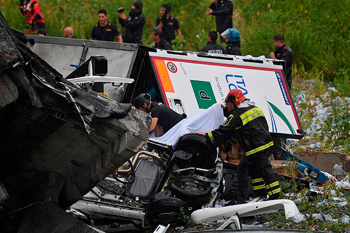 Rescues work among the debris of the collapsed Morandi highway bridge in Genoa, Italy, August. 14, 2018.