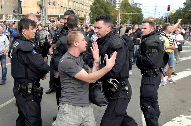 ×
None
A police officer pushes a man during a demonstration in Chemnitz, Germany, Monday, Aug. 27, 2018 after a man has died and two others were injured in an altercation between several people of “various nationalities” in the eastern German city of Chemnitz on Sunday. Slogan reads ‘No Access For Terror’.