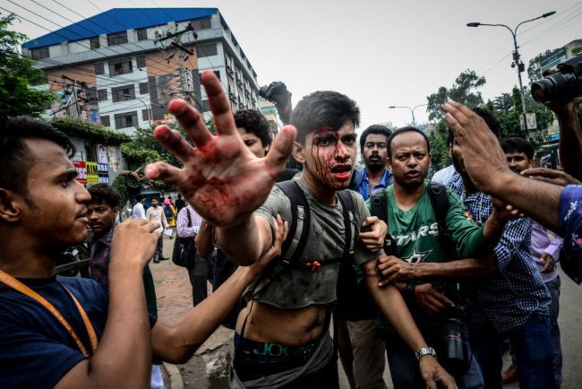 A photographer is targeted during a student protest in Dhaka on August 5, 2018, following the deaths of two college students in a road accident.