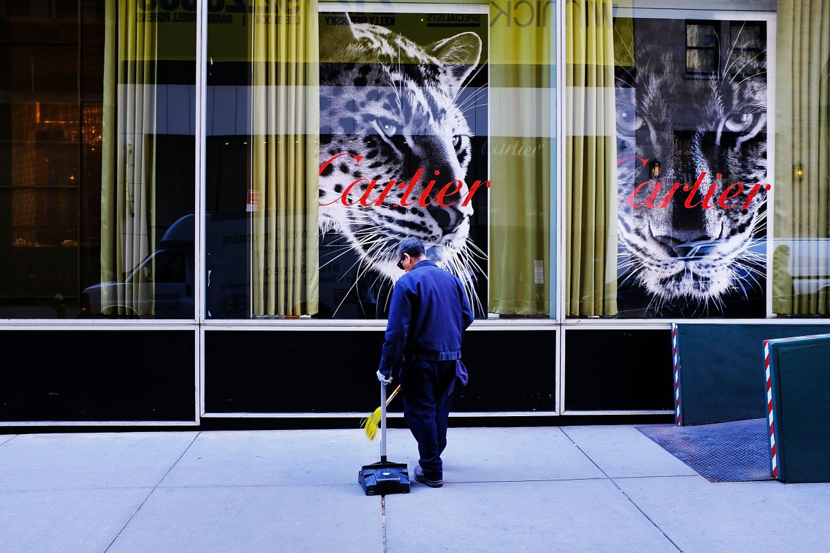A man cleans a sidewalk in front of the luxury jeweler Cartier in Manhattan on September 28, 2017 in New York City. 