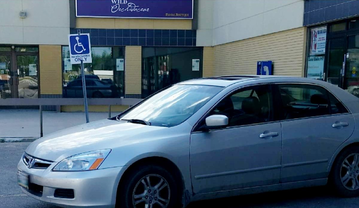 A car spotted illegally parking in an accessible parking spot. 