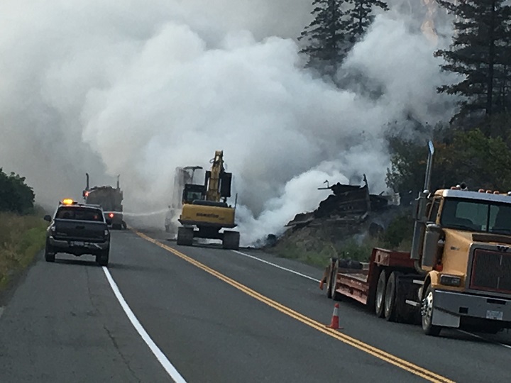 Clouds of steam rise as crews try to douse a fire alongside Highway 3 near Hedley, B.C., on Wednesday afternoon.