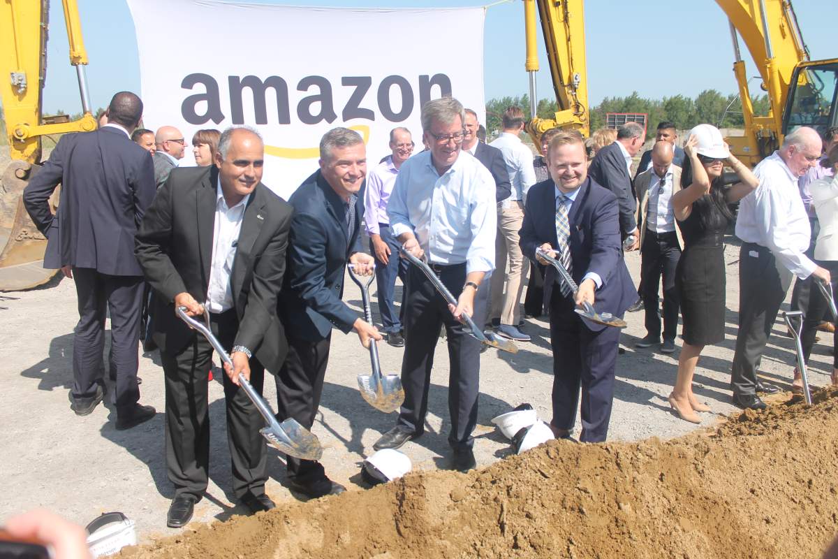 Ottawa Mayor Jim Watson along with city councillors George Darouze (left), Tim Tierney (second from left) and Stephen Blais (right) officially kick off the construction of the new Amazon fulfillment facility in the east end on Monday.
