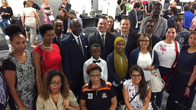 Economic Development and Trade Minister Deron Bilous stands with small business entrepreneurs during the announcement of the province's Immigrant Entrepreneur Program, Wed., Aug. 22, 2018. 