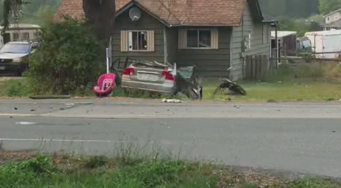 A badly damaged car and car seat seen at the side of the road after a serious crash in Langley, B.C., on Sunday.