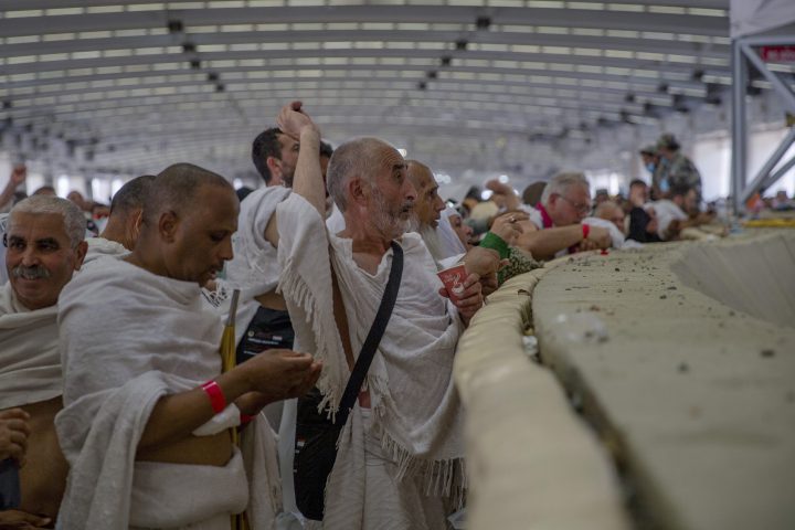 Muslim pilgrims cast stones at the huge stone pillar in the symbolic stoning of the devil during the annual Haj pilgrimage on the first day of Eid al-Adha in Mina, outside the holy city of Mecca, Saudi Arabia, Tuesday, Aug. 21, 2018.
