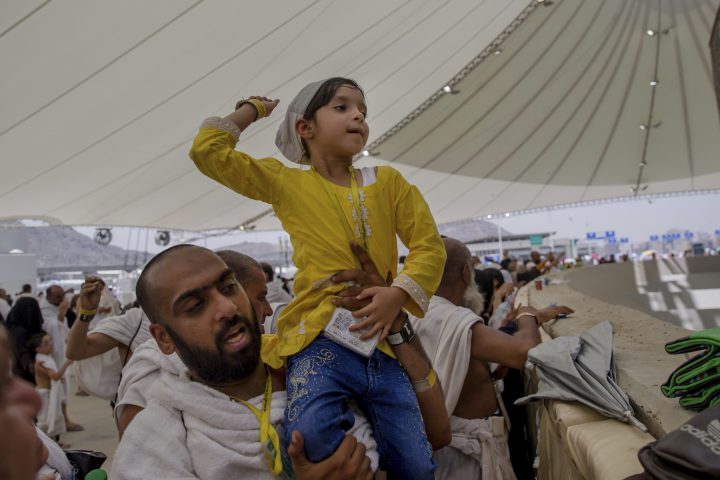 A girl joins in the symbolic stoning of the devil in Mina, Saudi Arabia, on Tuesday, Aug, 21, 2018.