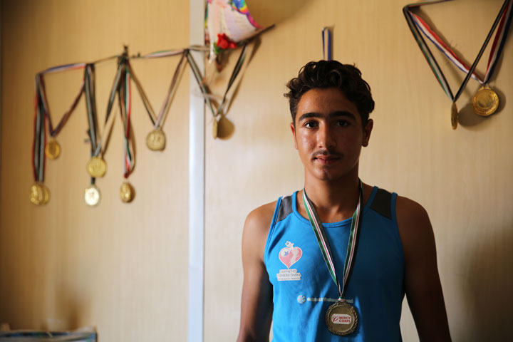 Mohammed Nakash, 16, with some of the medals he’s won at wrestling tournaments at the Zaatari Refugee Camp in Jordan.