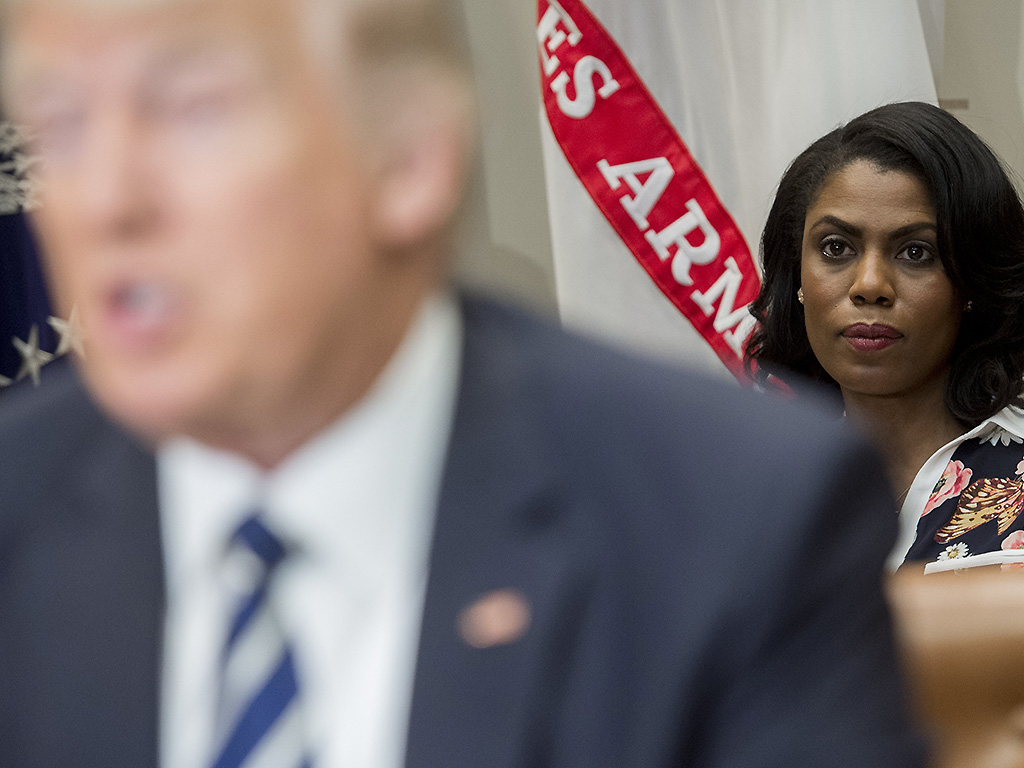 Omarosa Manigault Newman sits behind Donald Trump as he speaks during a meeting in the Roosevelt Room of the White House in Washington, DC, on February 14, 2017.